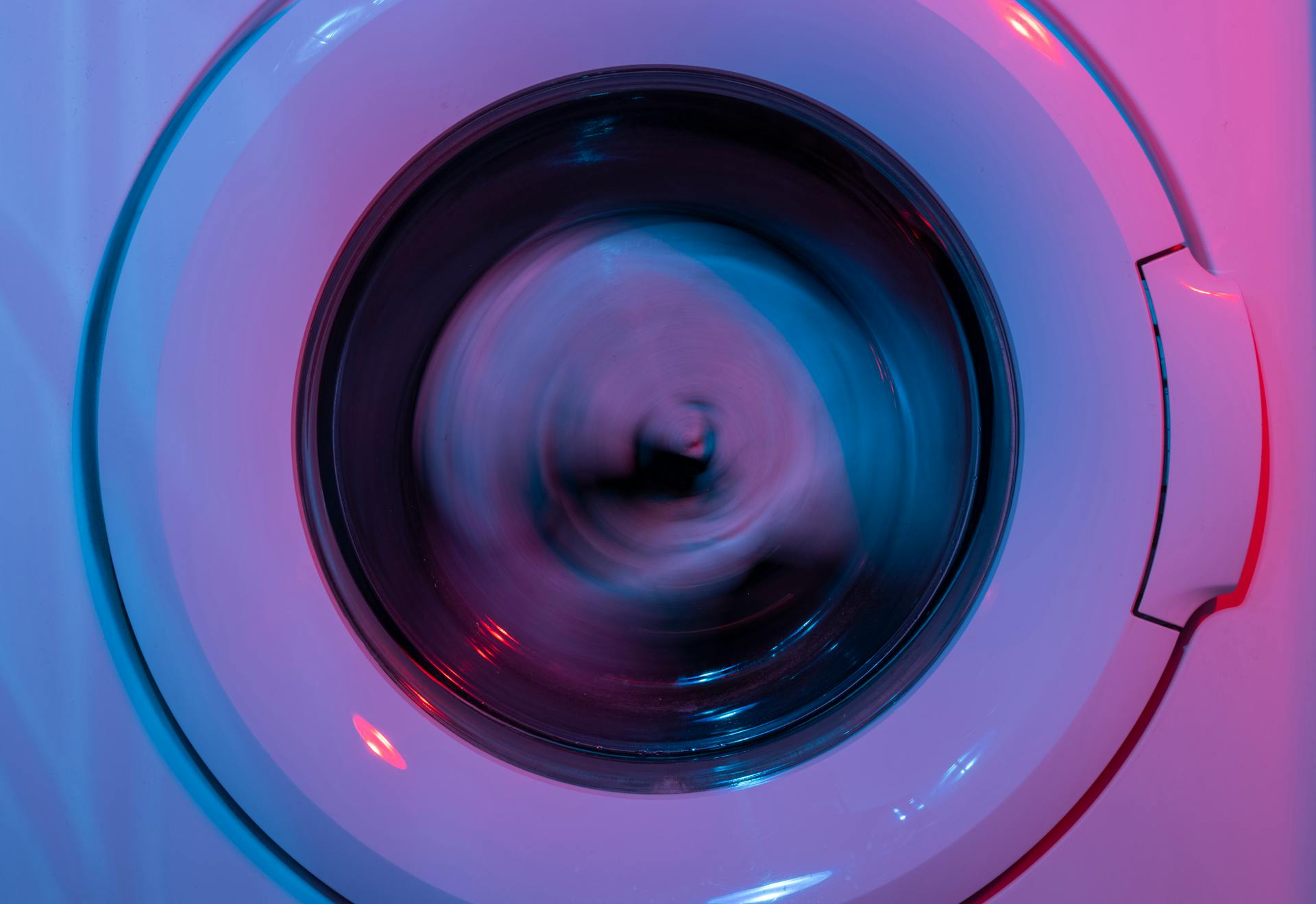 Close-up of wwashing machine in neon light