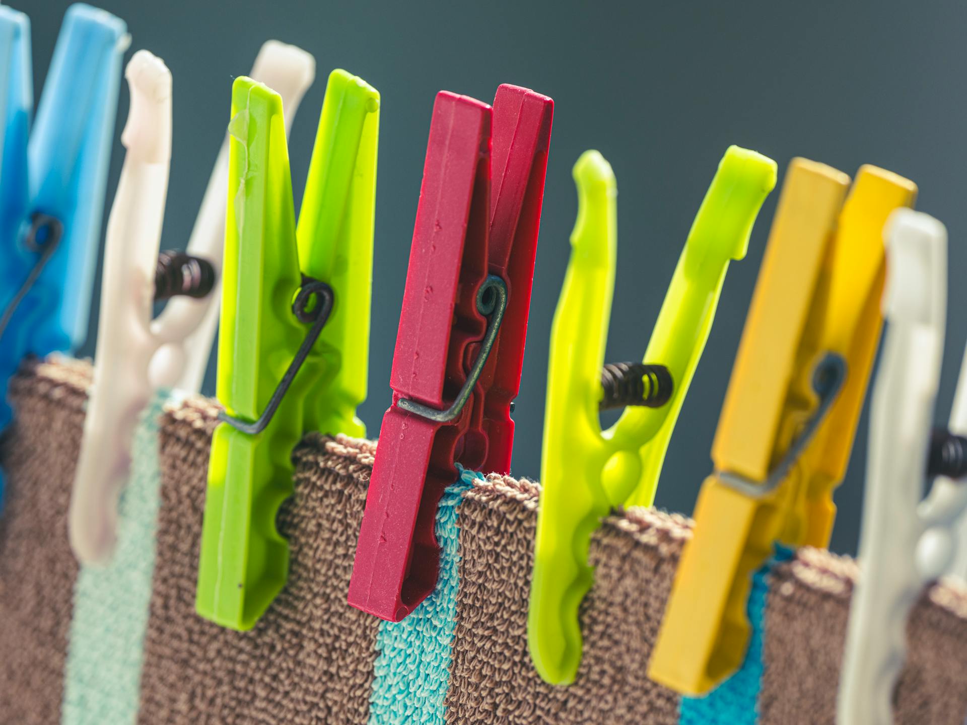 Colourful laundry pins on a washing line
